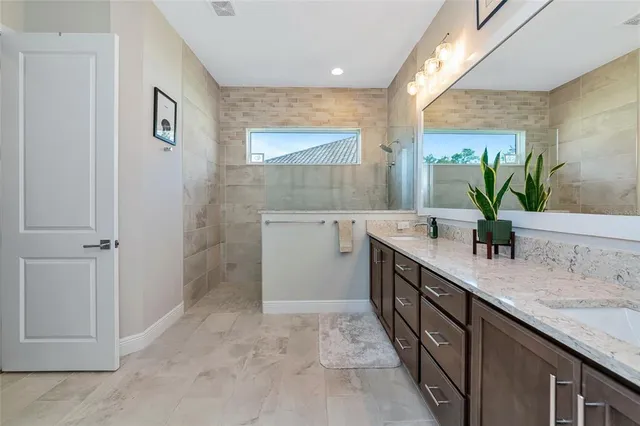 a living room with furniture a wooden floor and kitchen view