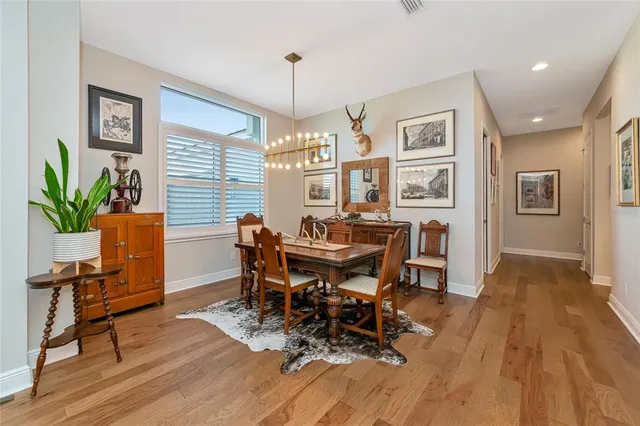 a living room with furniture kitchen view and a large window