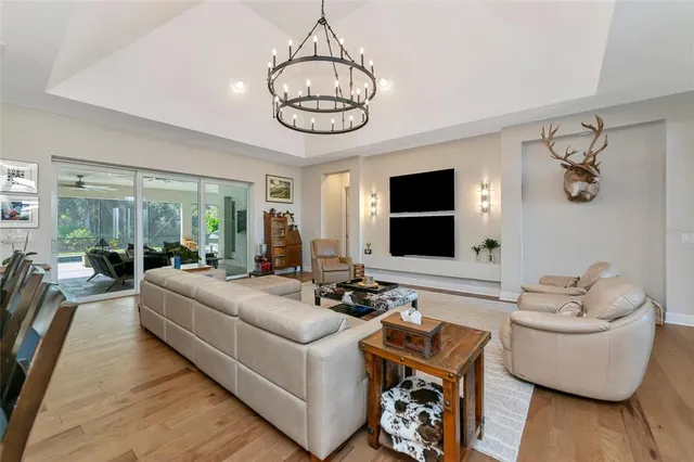 a kitchen with stainless steel appliances kitchen island granite countertop a table chairs and a refrigerator