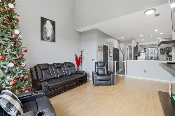 a living room with furniture and flowers