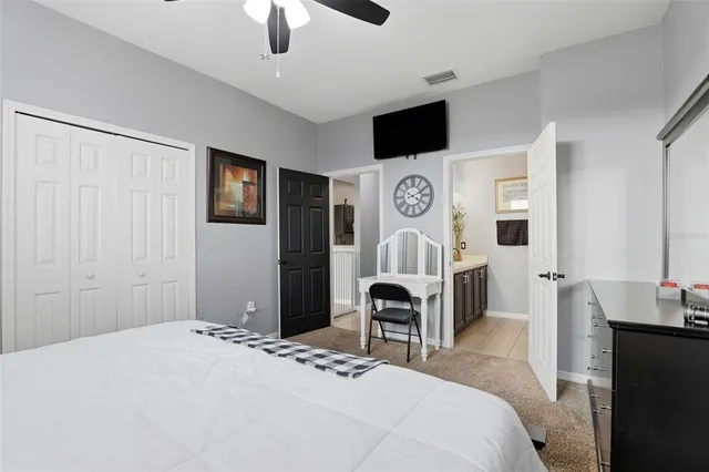 a bedroom with a bed and a television