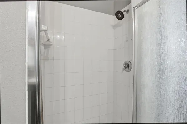 a bathroom with a glass shower door