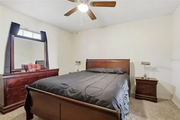 a bedroom with a bed and a mirror