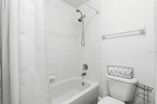 a white bath tub with a toilet