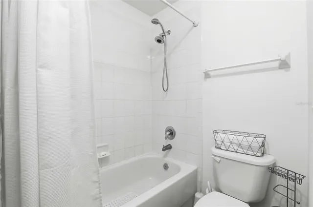 a white bath tub with a toilet