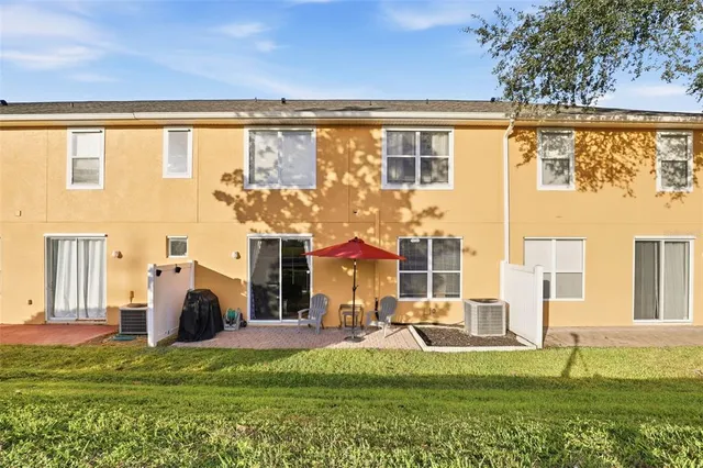 a view of a house with a big yard and large trees
