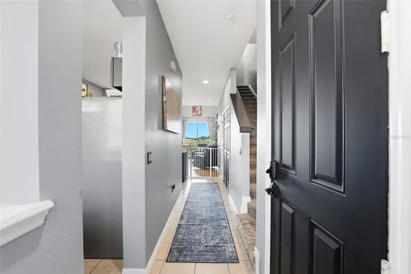 a view of a hallway with a livingroom and fireplace