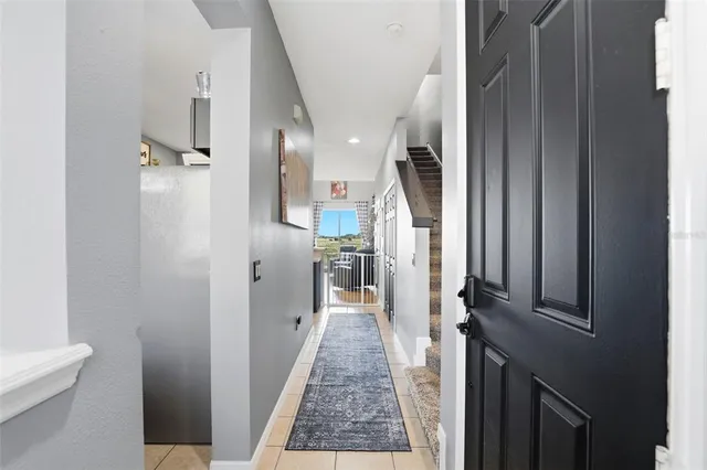a view of a hallway with a livingroom and fireplace