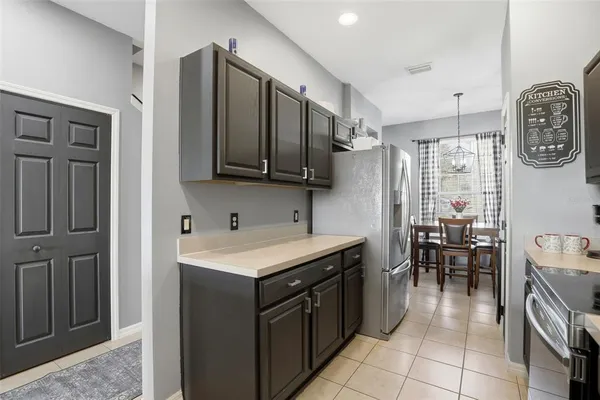 a kitchen with a sink a stove and a refrigerator