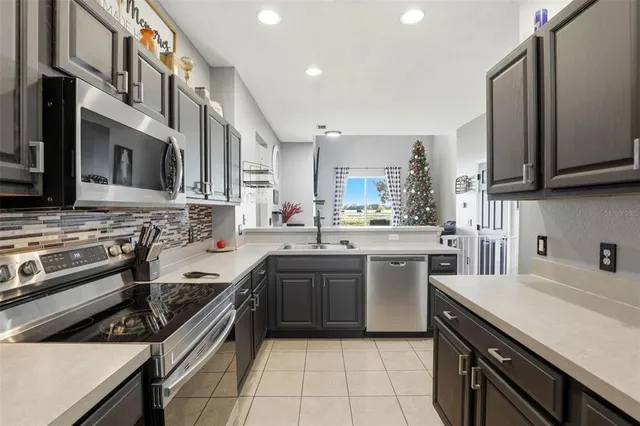 a kitchen with stainless steel appliances a stove sink and cabinets