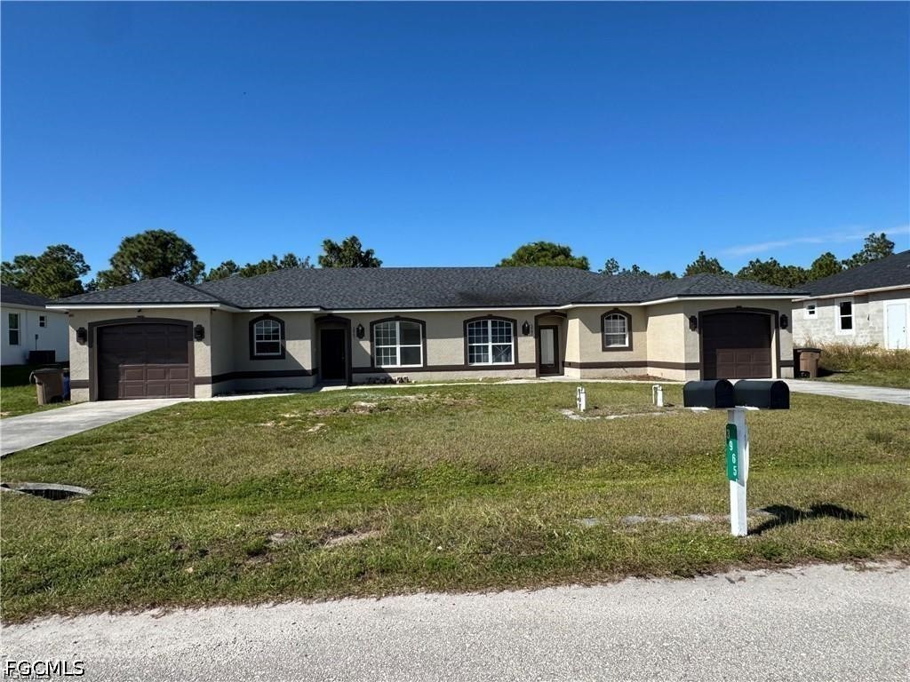 3967 Sunset Road Lehigh Acres, FL 33971 - Photo 1 of 10 front view of a house with a yard