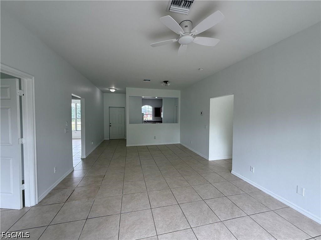 3967 Sunset Road Lehigh Acres, FL 33971 - Photo 2 of 10 an empty room with a empty space and a ceiling fan