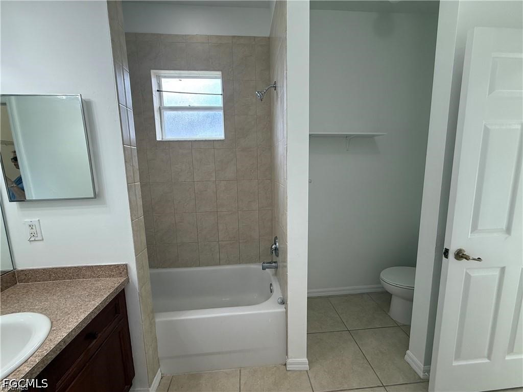 3967 Sunset Road Lehigh Acres, FL 33971 - Photo 9 of 10 a bathroom with a granite countertop sink toilet and shower