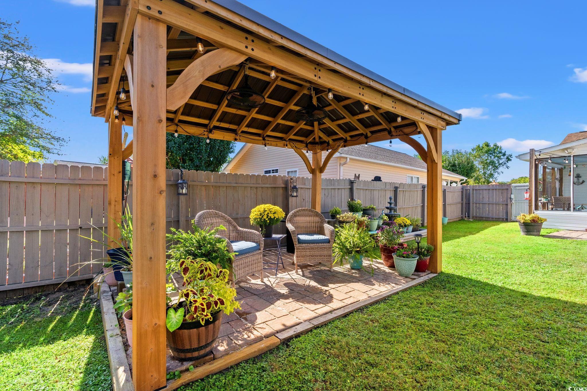 1283 Pollen Loop Murrells Inlet, SC 29576 - Photo 3 of 40 Fenced backyard with a gazebo, with ceiling fans string lights, and electrical, a patio,