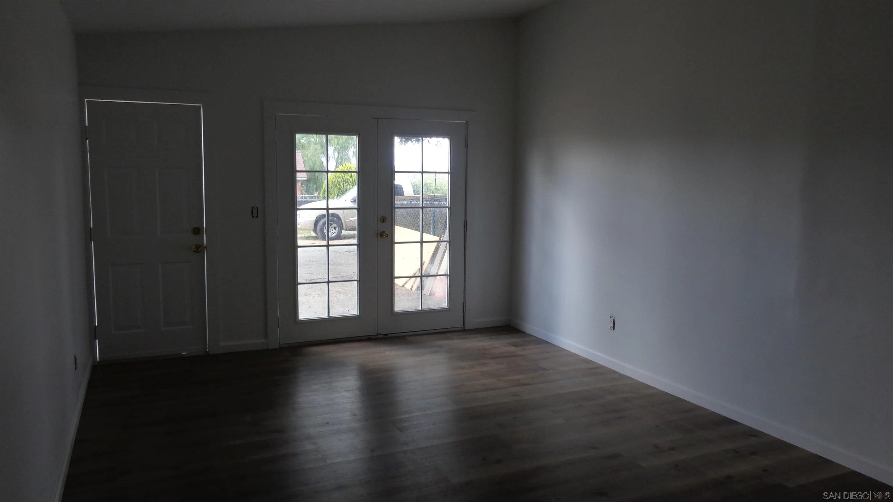 29660 Wilkes Road Valley Center, CA 92082 - Photo 5 of 16 a view of an empty room with wooden floor and a window