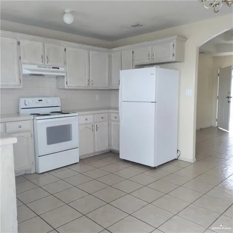 a kitchen with cabinets stainless steel appliances and sink