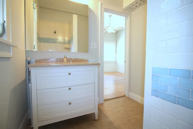 a bathroom with a sink a mirror and a shower
