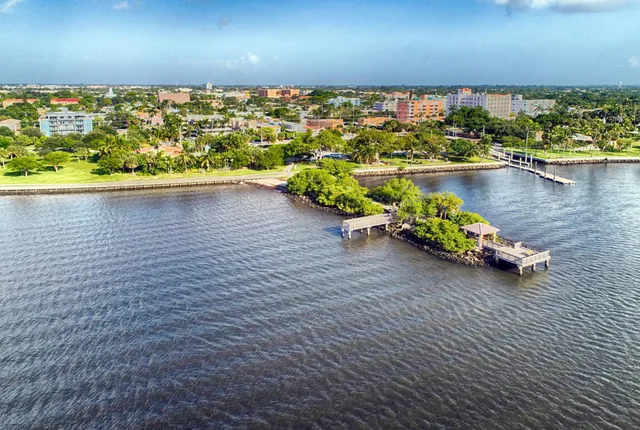 a view of a lake with lawn chairs