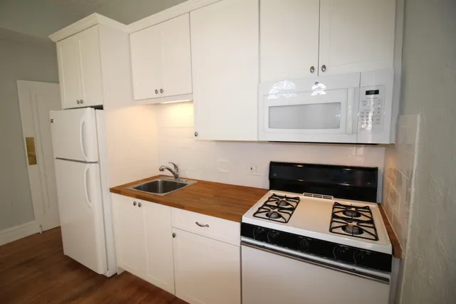 a kitchen with a sink cabinets and appliances