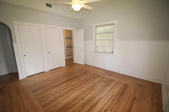 wooden floor in an empty room with a window