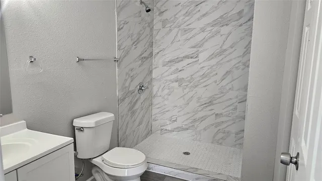 a white toilet sitting next to a shower curtain