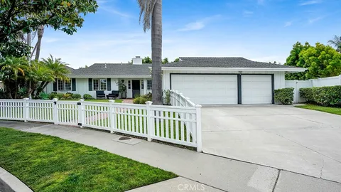 a front view of a house with a garden and yard