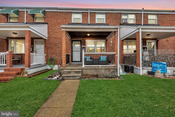 a view of a house with a yard porch and sitting area