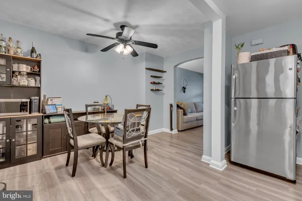 a view of a dining room with furniture and chandelier fan