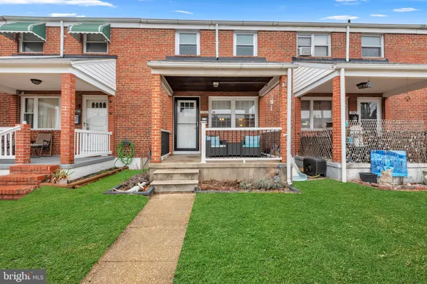 a view of a house with a yard porch and sitting area
