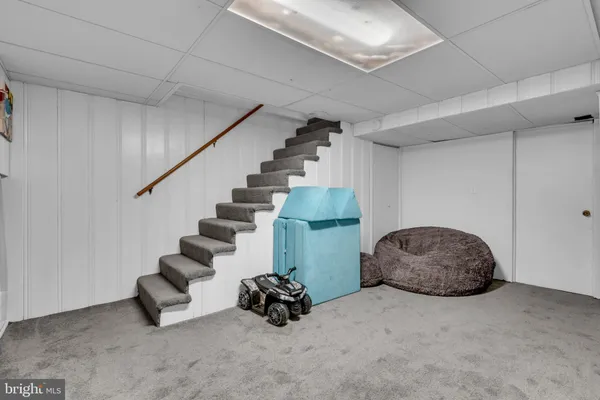 a view of a chair and tables in the patio