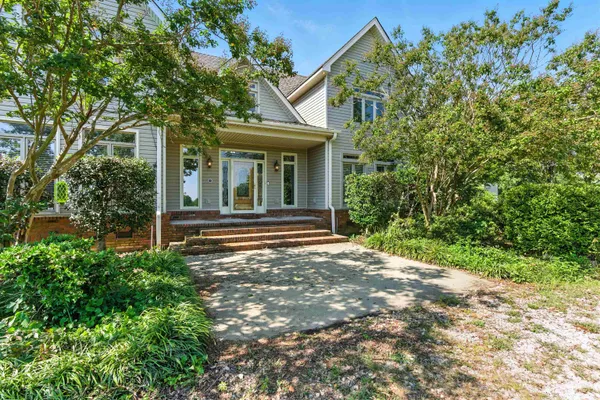 a view of a house with a small yard and plants