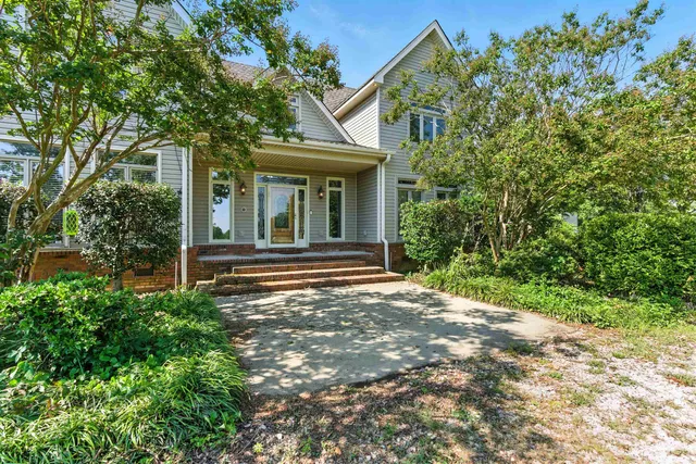 a view of a house with a small yard and plants