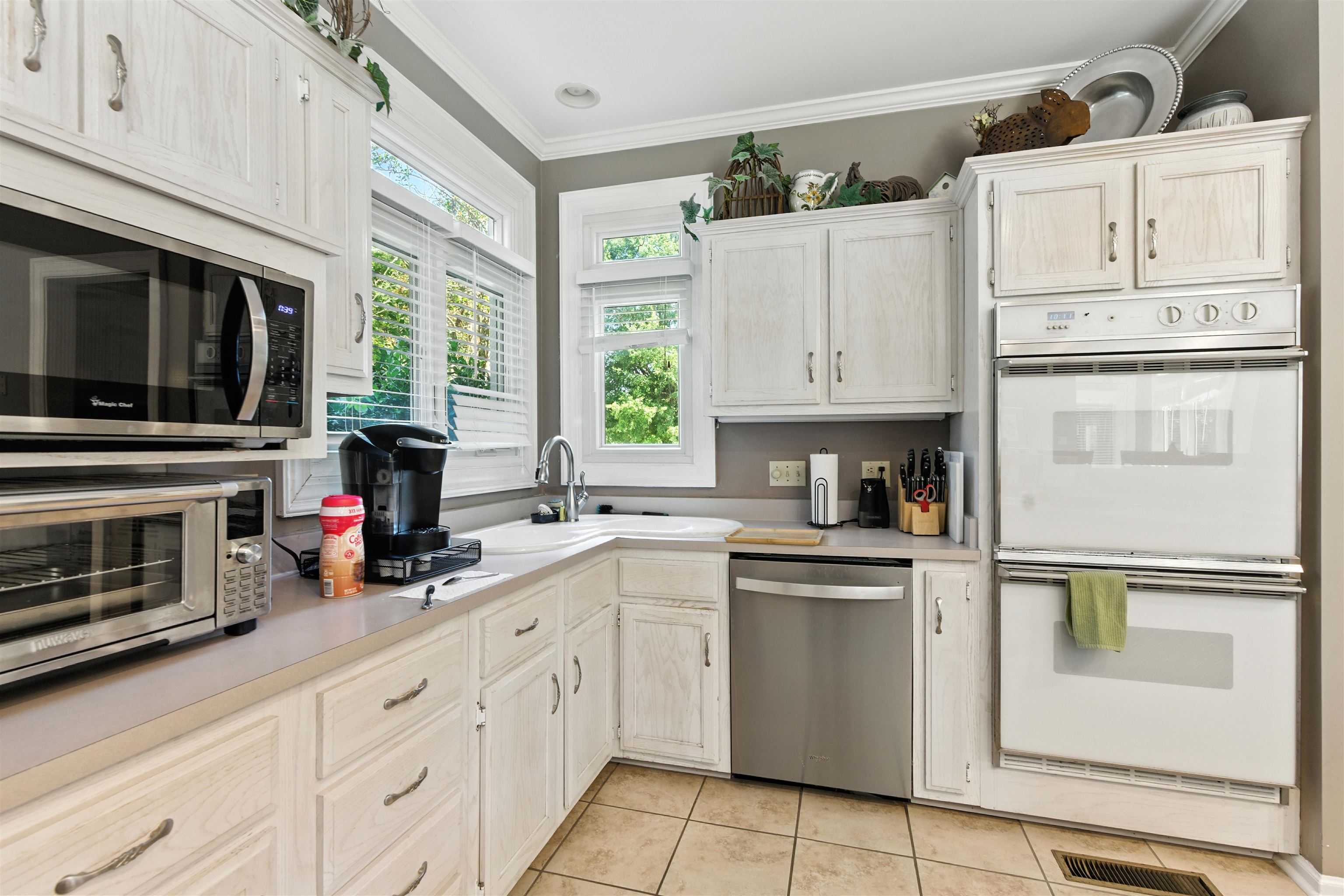 1452 Solo Road Covington, TN 38019 - Photo 12 of 39 a kitchen with white cabinets and appliances