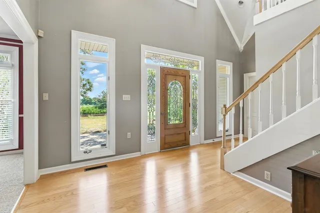 a view of an entryway with wooden floor and windows