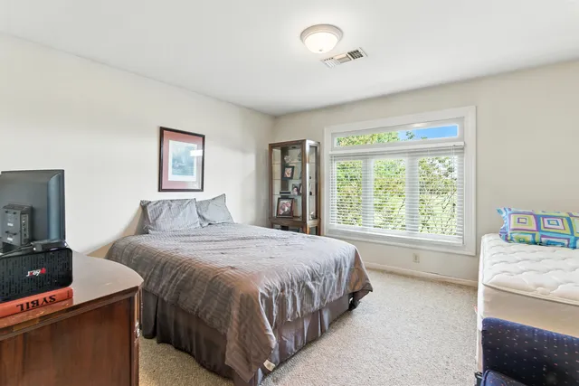 a bedroom with a large bed and a tv