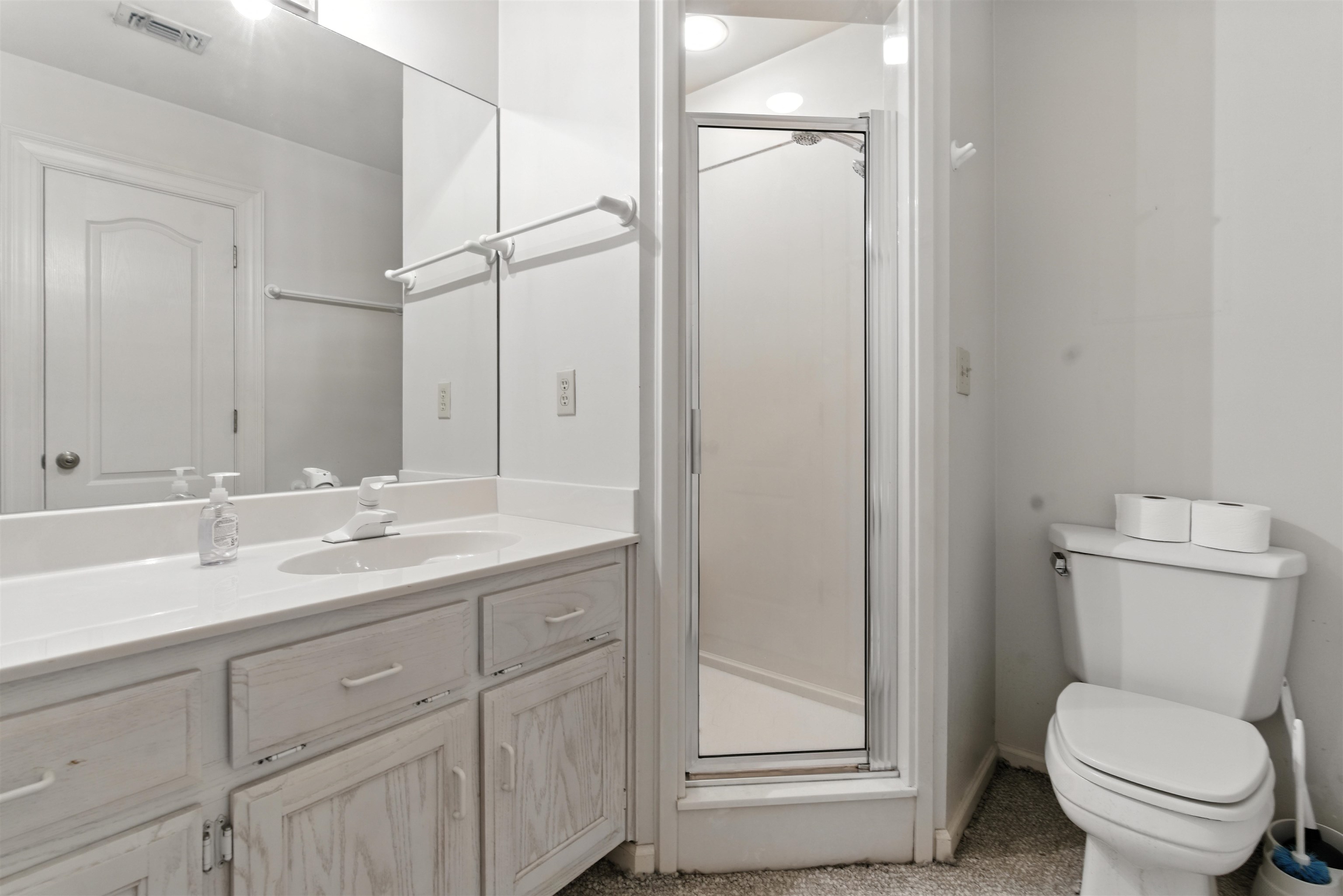 1452 Solo Road Covington, TN 38019 - Photo 20 of 39 a bathroom with a toilet a sink and mirror