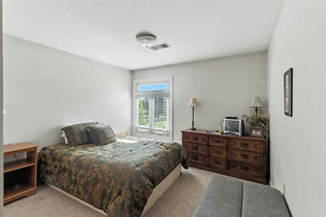 a bedroom with a bed and a dresser