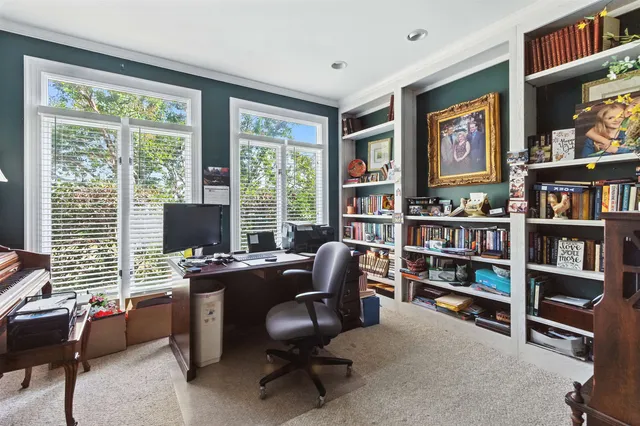 a view of a livingroom with workspace and a window