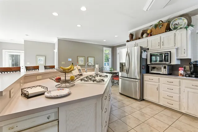 a kitchen with stainless steel appliances kitchen island granite countertop a sink and cabinets
