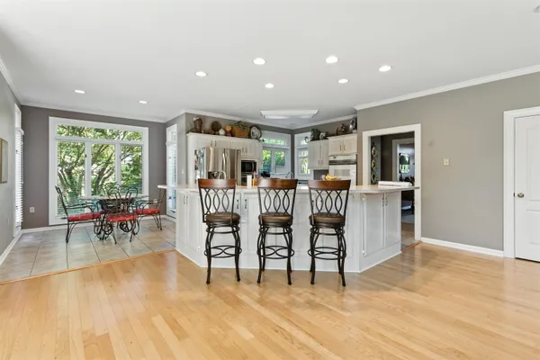 a kitchen with stainless steel appliances kitchen island granite countertop a sink and cabinets