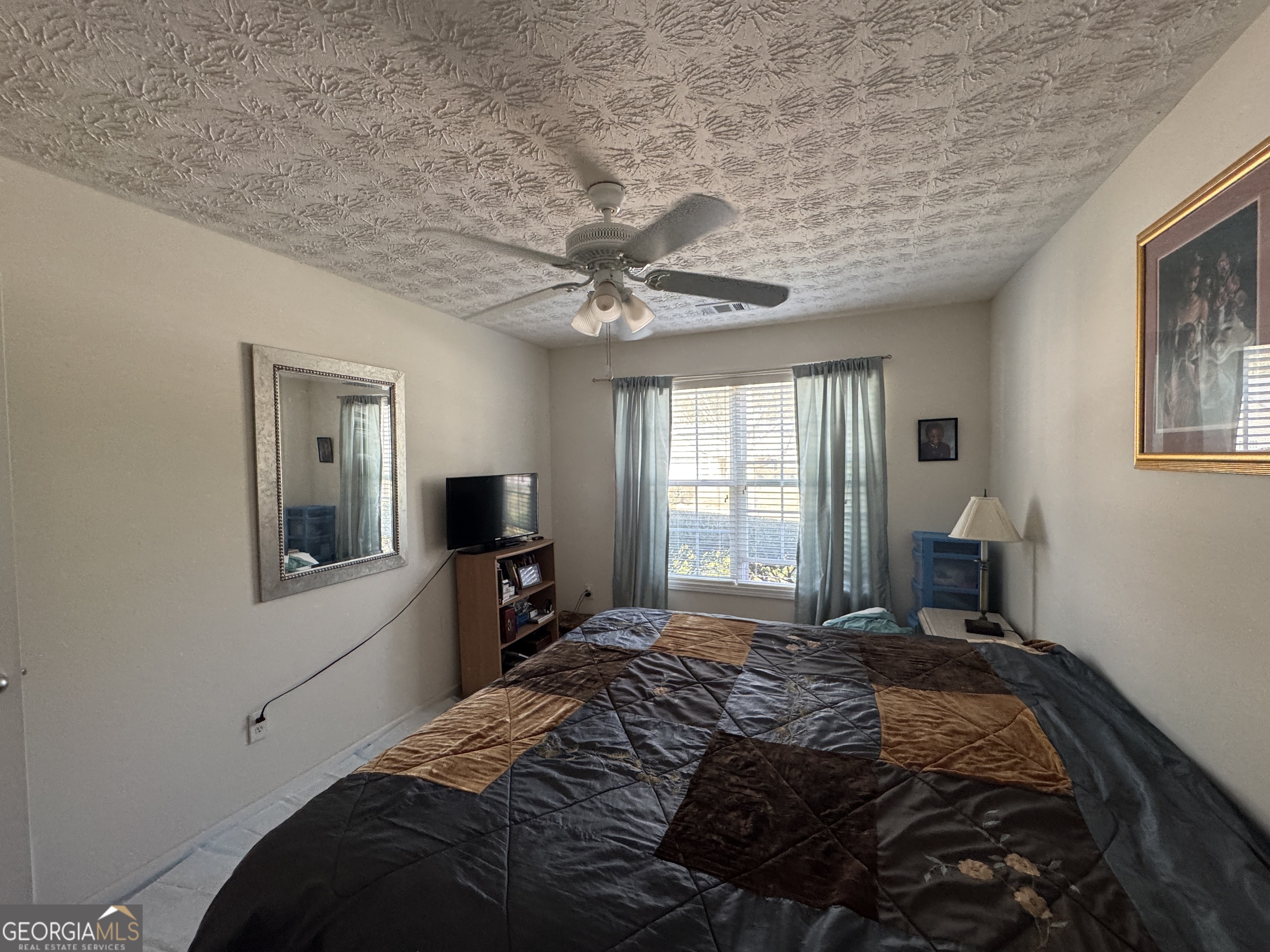 36 Windcrest Terrace Covington, GA 30016 - Photo 15 of 32 a bedroom with a large bed and a tv