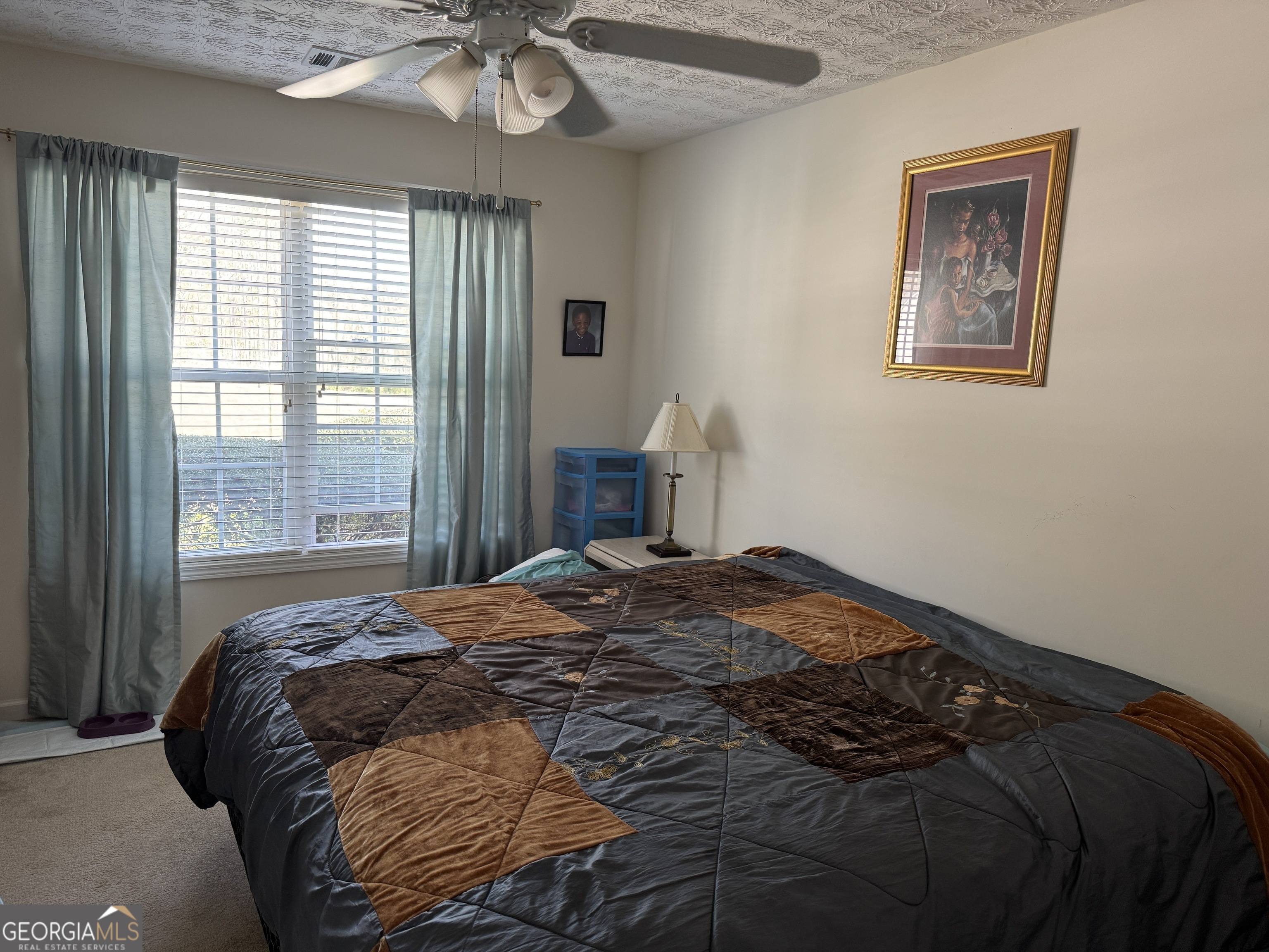 36 Windcrest Terrace Covington, GA 30016 - Photo 17 of 32 a bed sitting in a bedroom next to a window