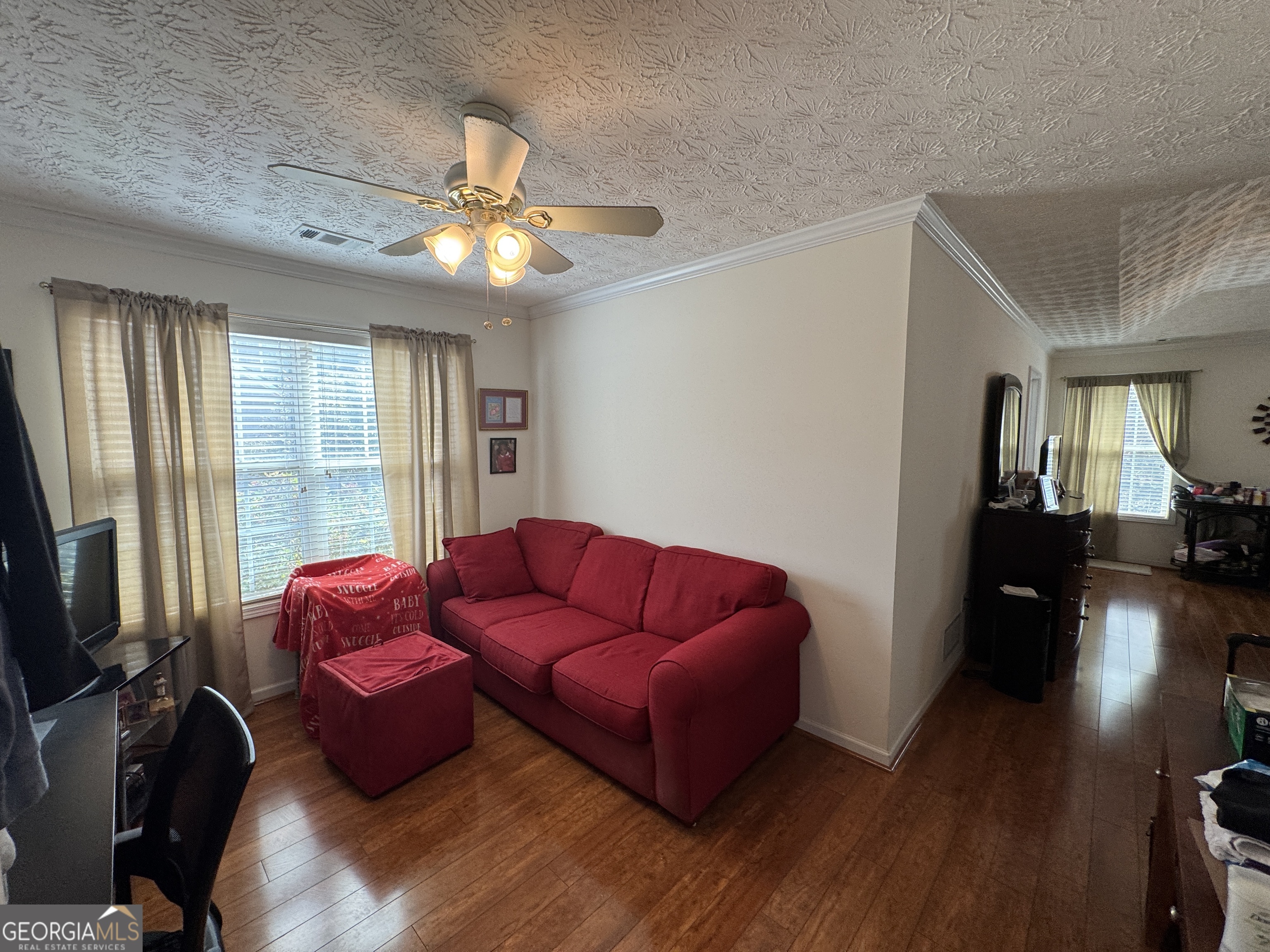 36 Windcrest Terrace Covington, GA 30016 - Photo 19 of 32 a living room with furniture a flat screen tv and a fireplace