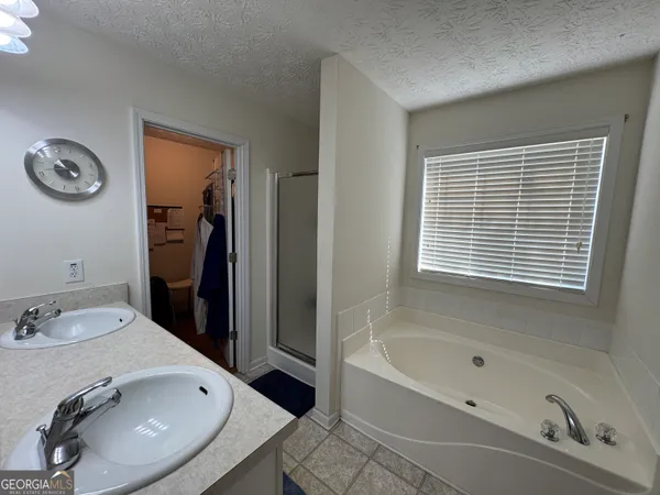 a bathroom with a tub sink and a window