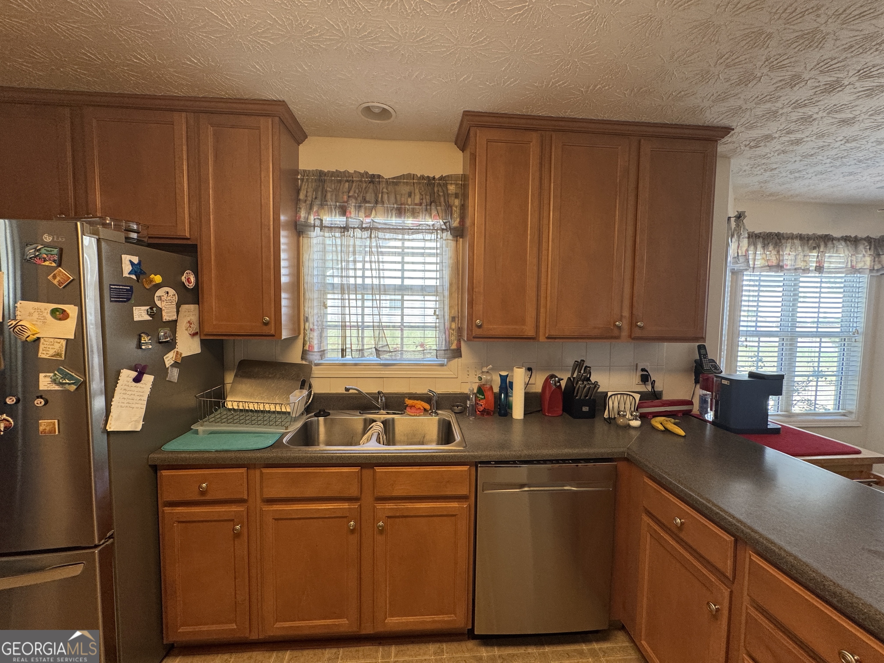 36 Windcrest Terrace Covington, GA 30016 - Photo 26 of 32 a kitchen with stainless steel appliances a sink stove and cabinets