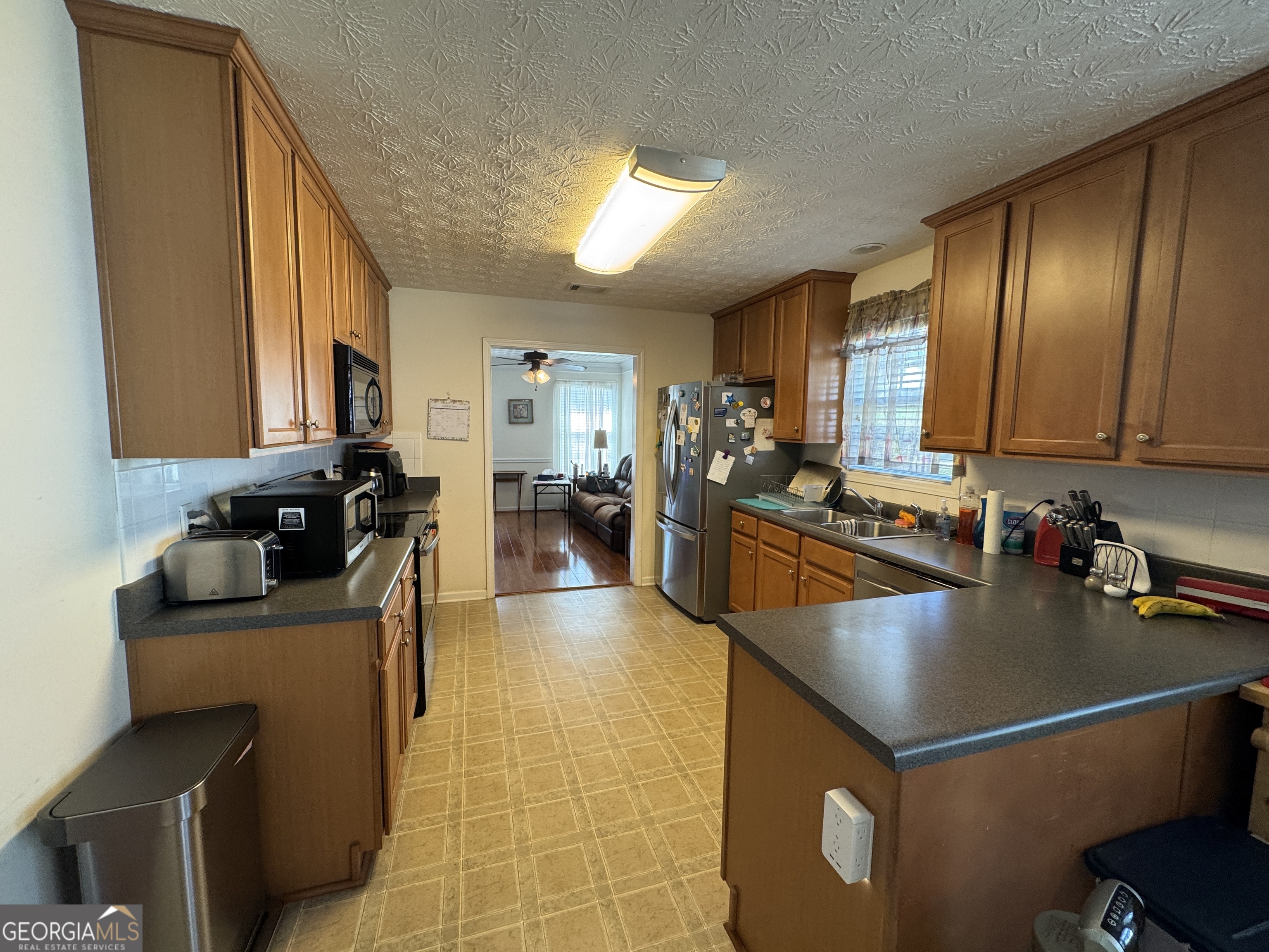 36 Windcrest Terrace Covington, GA 30016 - Photo 27 of 32 a kitchen with a refrigerator and a sink