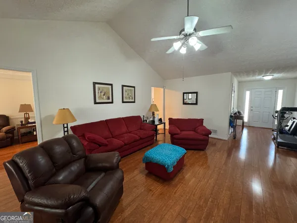 a living room with furniture and a chandelier