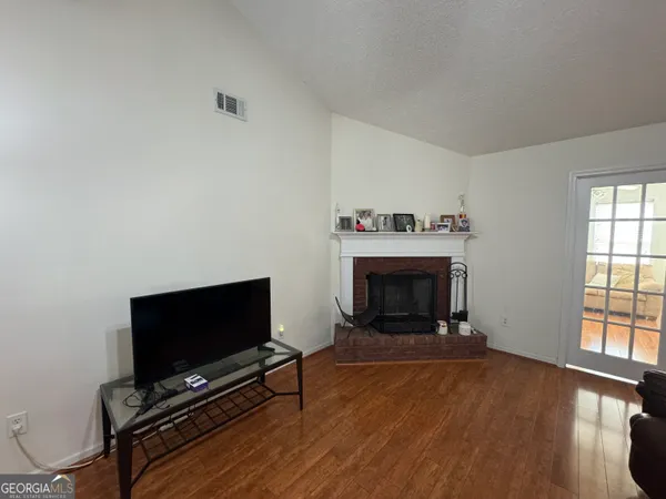 a living room with furniture a flat screen tv and a fireplace