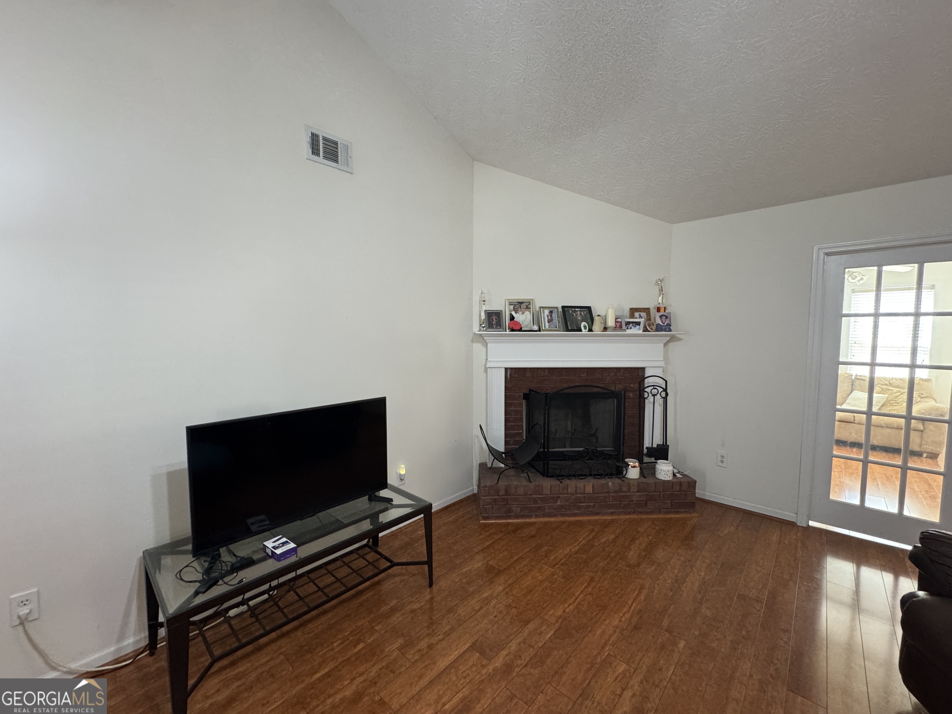 36 Windcrest Terrace Covington, GA 30016 - Photo 5 of 32 a living room with furniture a flat screen tv and a fireplace