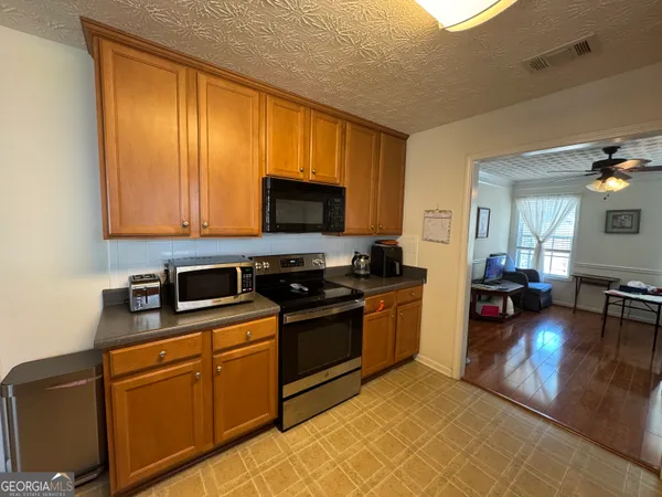 a kitchen with stainless steel appliances granite countertop a stove top oven a sink dishwasher and cabinets